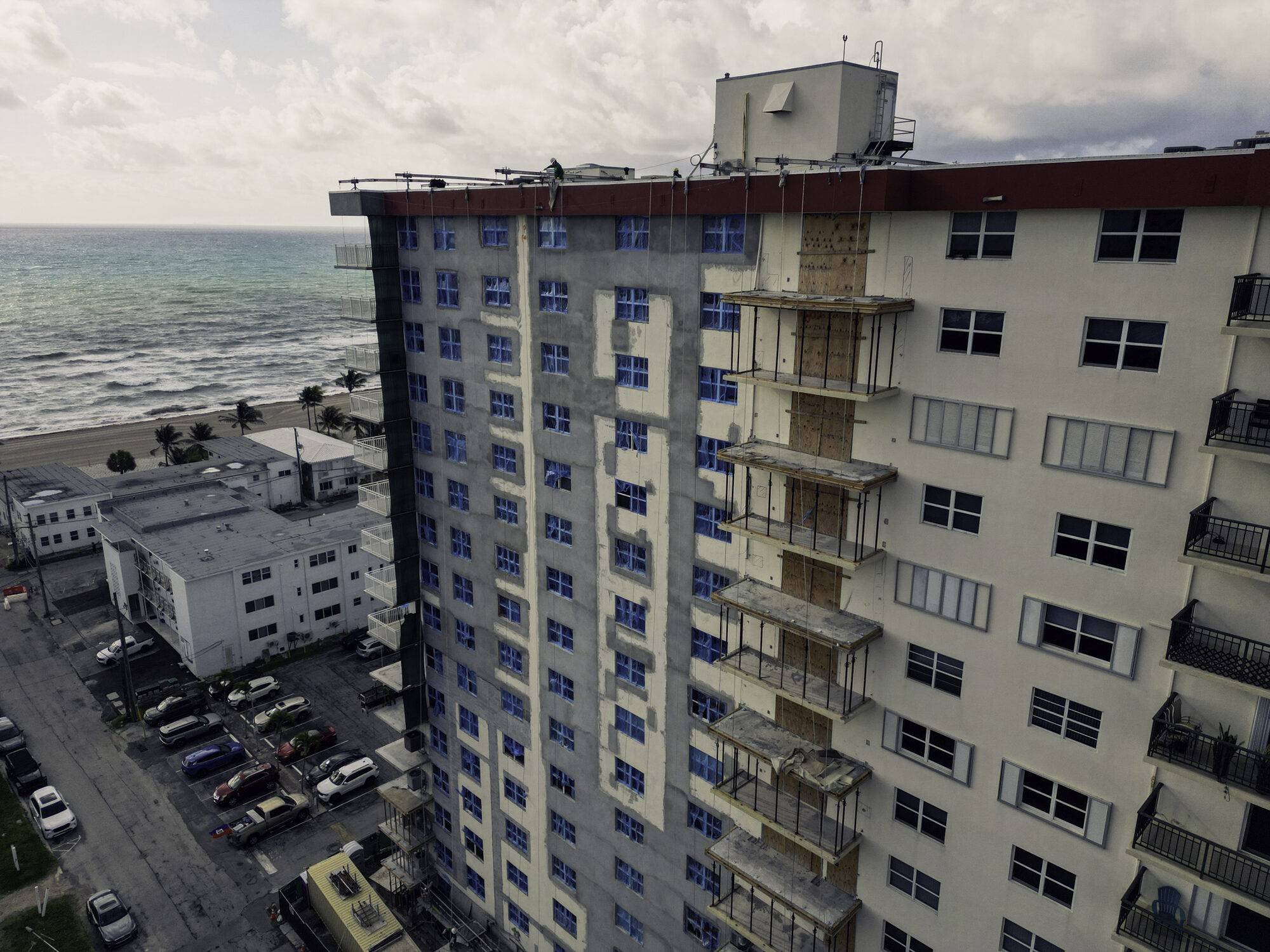 Oxford Towers oceanfront condominium under restoration in Hollywood, FL, with swing-stage access on the balconies
